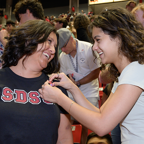 parent at pinning ceremony at convocation with her student/daughter